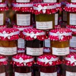 Colorful display of gourmet jam jars with decorative polka dot covers, perfect for artisanal food markets.