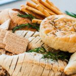 Delicious variety of artisan breads and crackers garnished with fresh rosemary.