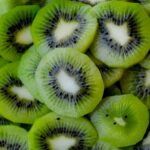 Close-up of fresh, vibrant green kiwi slices, showcasing texture and color.